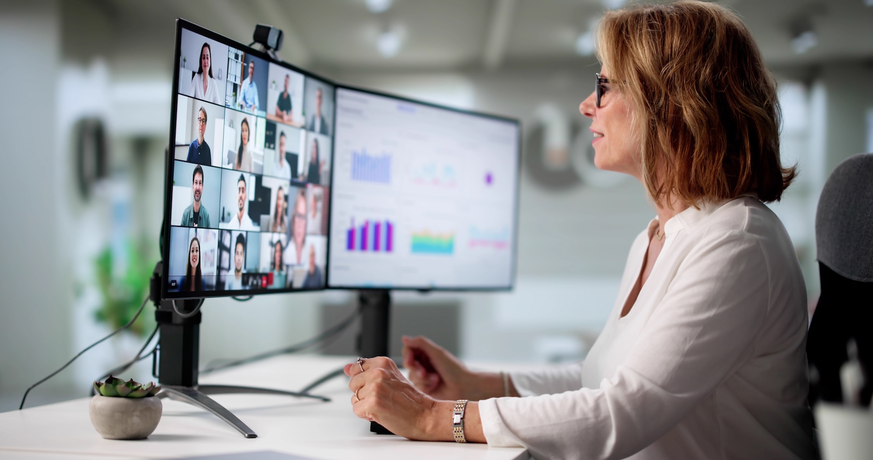 Woman Holding Video Conference Call With Remote Workers From Office.
